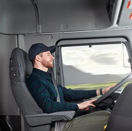 A truck driver sitting comfortably in the Hyundai XCIENT Fuel Cell Tractor